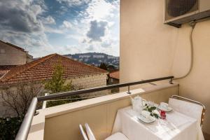 a white table on a balcony with a view at Apartment Buby in Dubrovnik