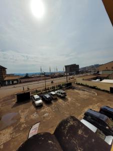 a parking lot with cars parked in a parking lot at Hôtel Altitel in Bafoussam