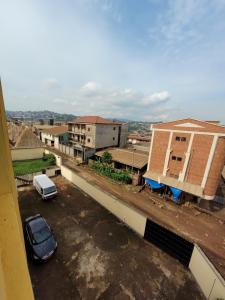 a car parked in a parking lot next to a building at Hôtel Altitel in Bafoussam