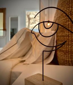 a black lamp sitting on a table next to a bed at Casa Armonía in Morro del Jable