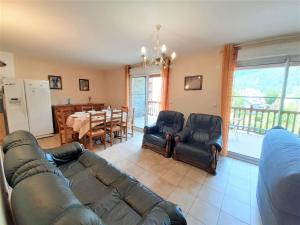 a living room with a couch and chairs and a table at Appartement Saint-Lary-Soulan, 3 pièces, 8 personnes - FR-1-457-183 in Saint-Lary-Soulan