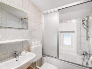 a bathroom with a toilet and a sink and a shower at Apartment Rupertus-4 by Interhome in Maishofen