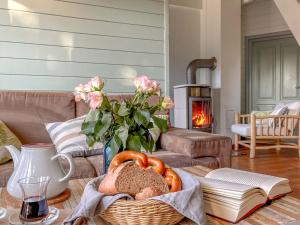 a table with a basket of bread and a fireplace at traumHaff Bootsmanns Domizil Kamin, privates NORDICSPA, Boot in Rieth am See in Rieth