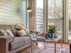 a living room with a couch and a coffee table at traumHaff Bootsmanns Domizil Kamin, privates NORDICSPA, Boot in Rieth am See in Rieth