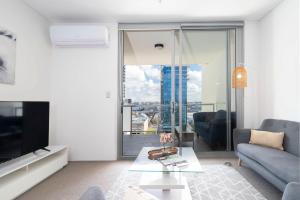 a living room with a couch and a tv at 152 City Rest With Views High Upparking Sleeps 2 in Perth
