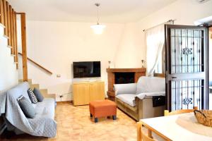 a living room with a couch and a tv at La Luna sul lago in Trevignano Romano