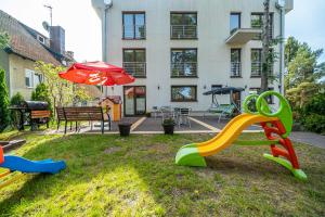 a playground with a slide in the yard of a house at Willa Magda in Jastrzębia Góra