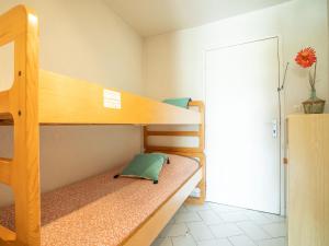 a bedroom with two bunk beds and a doorway at Studio Ulysse Plage-9 by Interhome in La Grande Motte