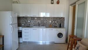 a kitchen with a washing machine and a washer at 80 Steps - Beach Apartment in Hanioti