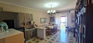 a kitchen and living room with a table and chairs at B&B Aria di Mare - Pollina Sicilia in Finale