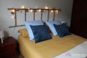 a bedroom with a bed with blue pillows at Apartamento Nansa - Casas de los Picos in Celis