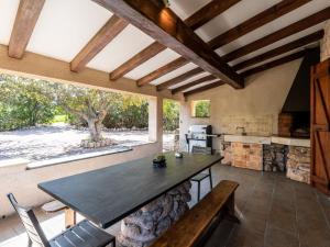 a kitchen with a table and chairs and a large window at Holiday Home St- Joseph by Interhome in Propriano