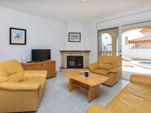 a living room with couches and a tv and a table at Holiday Home Villa Kikidona by Interhome in Miami Platja