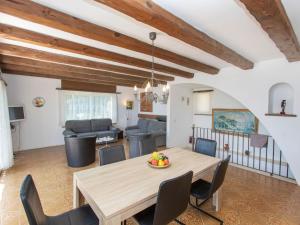 a dining room with a wooden table and chairs at Holiday Home Puig Romani-2 by Interhome in Platja  d'Aro