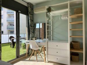 a room with a table and chairs and a window at Solàrium con terraza a 5 minutos de la playa in Girona