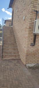 a brick stairway next to a brick building at Royal Palms Guest Lodge in Newcastle