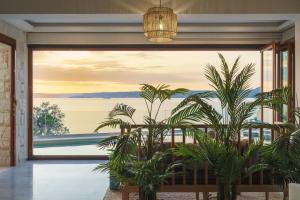 a living room with a view of the water at Villa Almy in Plaka