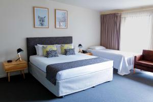 a hotel room with two beds and a chair at The Manna, Ascend Hotel Collection in Hahndorf
