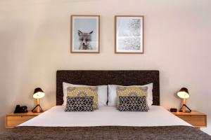 a bedroom with a bed with two pictures on the wall at The Manna, Ascend Hotel Collection in Hahndorf