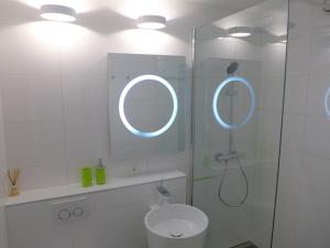 a bathroom with a shower with a toilet and a mirror at Apartment Jeanne D'Arc Apt- C-19 by Interhome in Crans-Montana