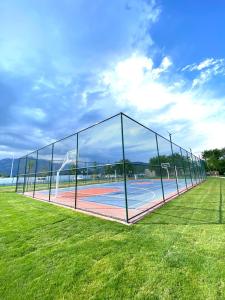 a basketball court with a net in a field at İstanbul Beach Hotel in Kemer