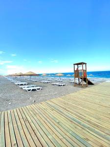 a beach with chairs and umbrellas on the beach at İstanbul Beach Hotel in Kemer