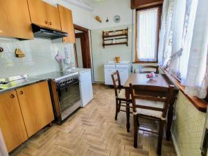 a small kitchen with a table and chairs in it at Apartment Betti by Interhome in Domaso