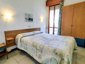 a small bedroom with a bed and a window at Apartment Domaso by Interhome in Domaso