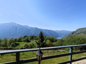 a street light on a fence with mountains in the background at Chalet Merlo by Interhome in Porlezza