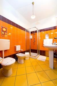 y baño con 2 aseos, ducha y lavamanos. en La Chiusa Case Vacanze, en Castellammare del Golfo