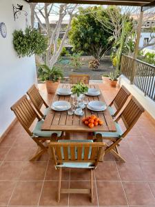 a wooden table and chairs on a patio at Casa Lava in Yaiza