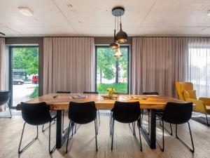 a dining room with a wooden table and chairs at numa I Stark Rooms & Apartments in Munich