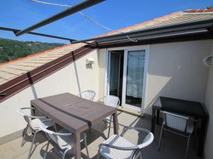 a patio with a table and chairs on a balcony at Apartment I Monili-4 by Interhome in Moneglia