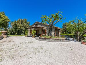 a house with a gravel driveway in front of it at Holiday Home Podere Cafaggiolo-2 by Interhome in Volterra