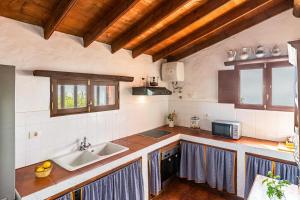 a kitchen with a sink and a counter at Casa Rural La Caldera in Teror