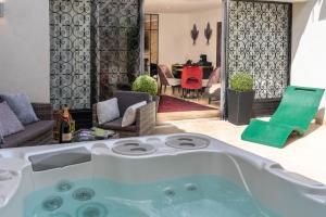a bath tub in the middle of a living room at Le Confidentiel Hôtel & SPA in Saint-Raphaël