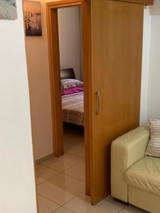 a door leading to a bedroom with a bed at VIP Resort Apartment on Makenzie Beach in Larnaca