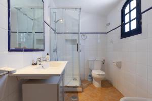 a bathroom with a sink and a shower and a toilet at Casa Altavista in Alora +30 photos