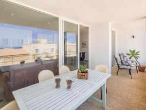 una mesa blanca y sillas en la sala de estar. en Apartment Misefo - PIC275 by Interhome, en Son Serra de Marina