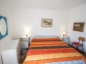 a small bedroom with a bed and two night stands at Apartment Casa Centrale by Interhome in Moneglia +13 photos