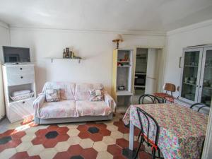 a living room with a couch and a table at Apartment Casa Centrale by Interhome in Moneglia