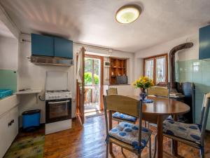 a kitchen and dining room with a table and chairs at Apartment Ardene - MCG451 by Interhome in Vigino