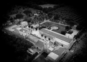 an aerial view of a large house with a clock at MASSERIA LILEI in Lizzanello