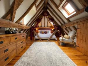 a bedroom with a bed in a attic at Elegant peaceful barn in rural village setting close to Stratford upon Avon in Stratford-upon-Avon
