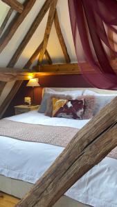 a bedroom with two beds in a attic at Elegant peaceful barn in rural village setting close to Stratford upon Avon in Stratford-upon-Avon