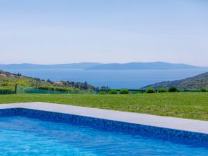 a swimming pool with a view of the water at Holiday Home Panorama 1 by Interhome in Labin