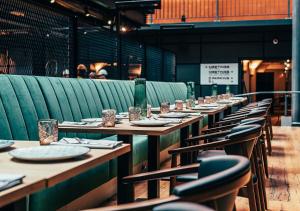 a row of tables and chairs in a restaurant at Clarion Hotel Mestari in Helsinki
