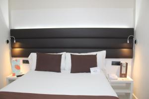 Postel nebo postele na pokoji v ubytování BCN Urbaness Hotels Del Comte
