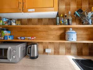 a kitchen with a counter top with a microwave at Apartment Holger by Interhome in Zell am See +50 photos