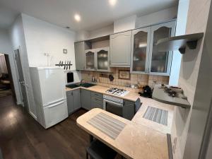 a kitchen with a white refrigerator and a sink at Kingsize bed Self check in & Smart tv and Parking in Rīga